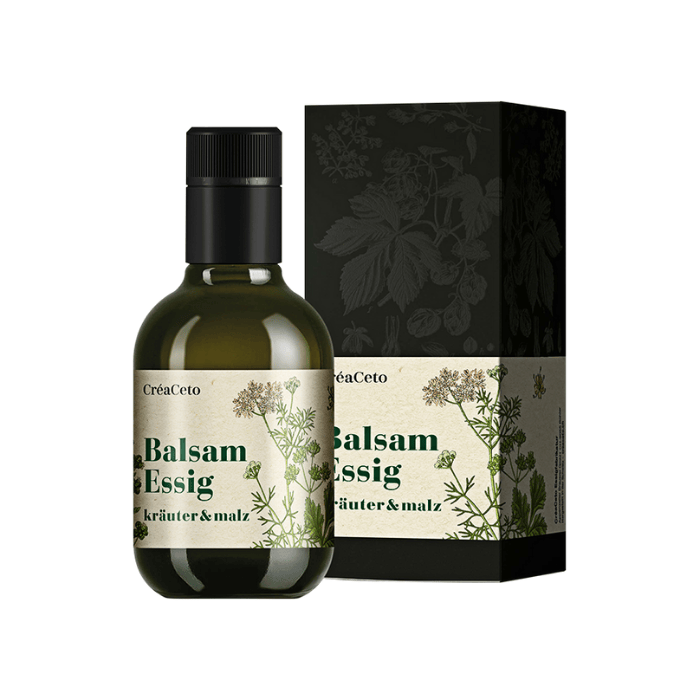 Balsam Essig Kräuter und Malz Flasche und Verpackung vor weissem Hintergrund