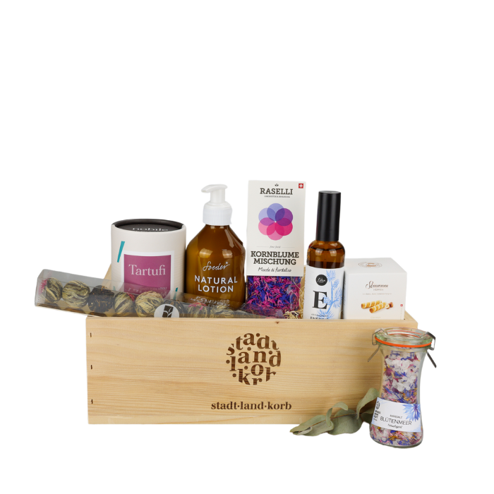 Sweet Spa Moments Geschenkkorb vor weissem Hintergrund befüllt mit Tarutfi, Teekugeln, Soeder Naturlotion, Raselli Kornblumen, Energie spray, Straumannhüppen und Blütenmeer Badesalz