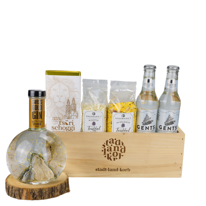 Truffle & Tonic Geschenkkorb vor weissem Hintergrund befüllt mit Swiss Gold Gin, Tsüri Schoggi, Trüffel Risotto, Trüffel Plolenta und Tonic